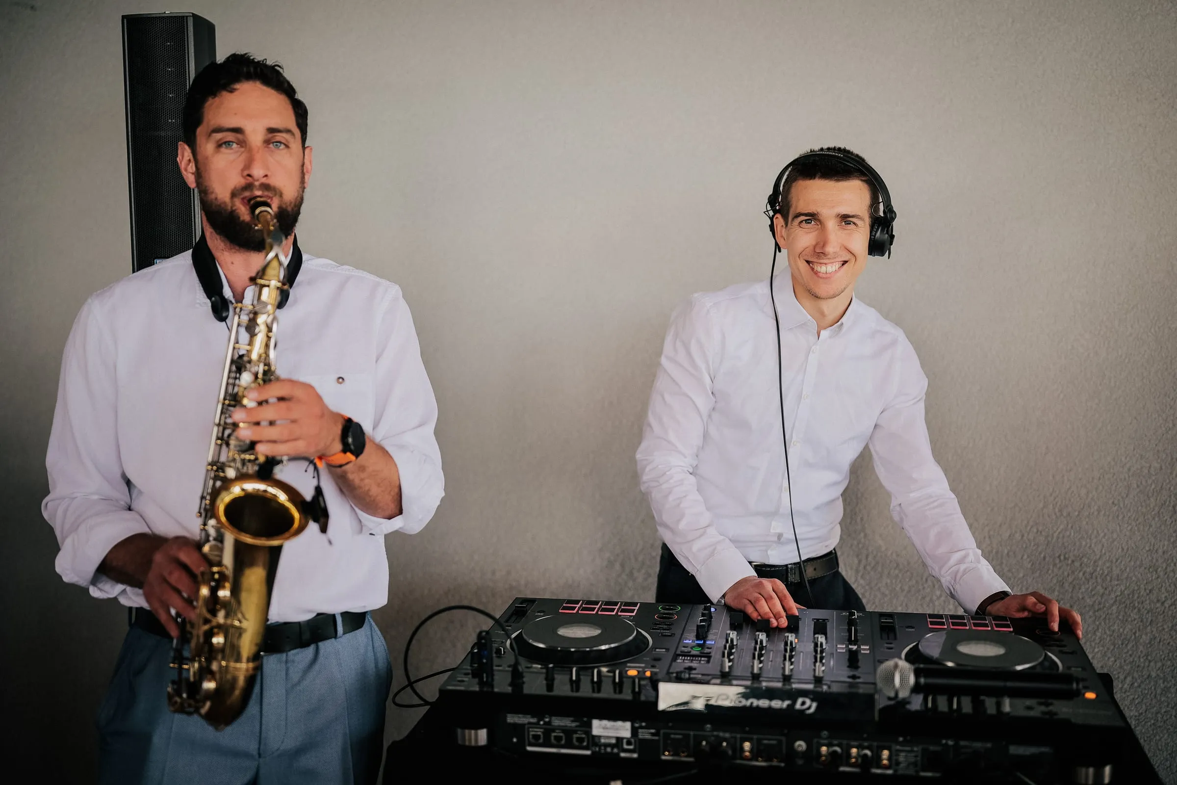 DJ Symart and a saxophonist performing together at a wedding in Pula