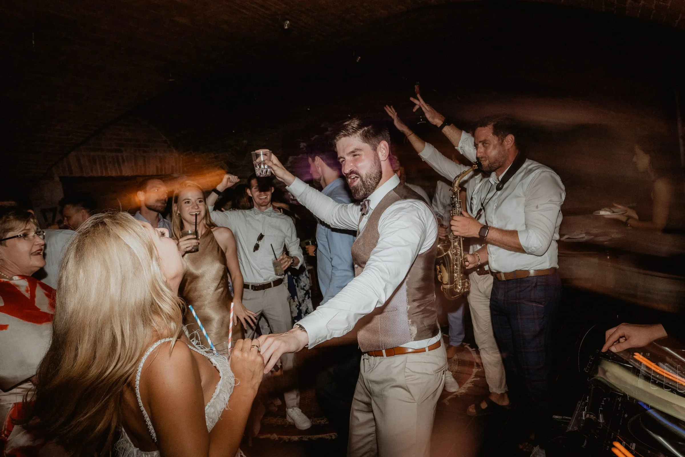 Guests dancing with a saxophonist under the stone vaults of Fort George on Vis
