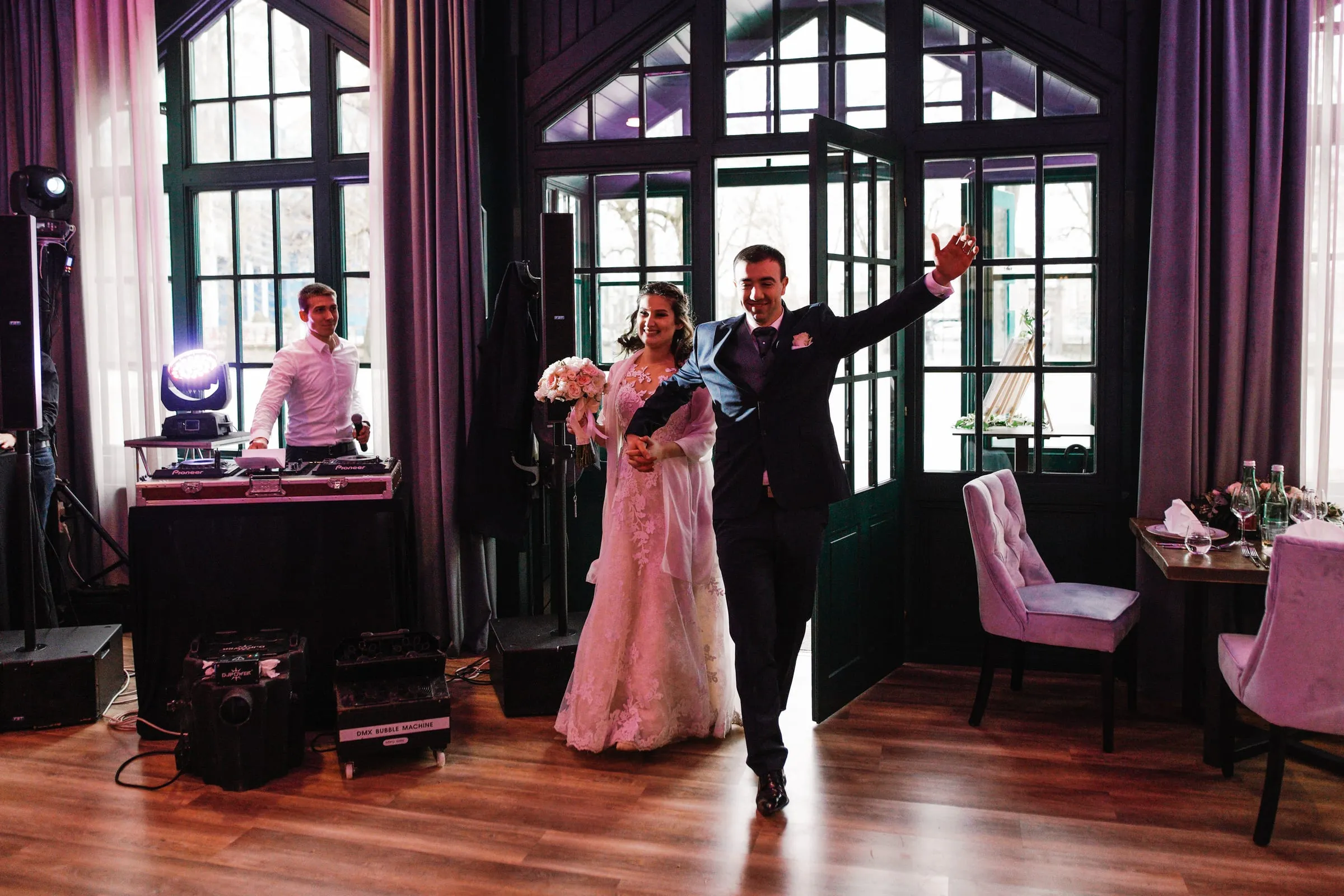 Newlyweds dancing in front of the DJ booth at Restoran Maksimir in Zagreb