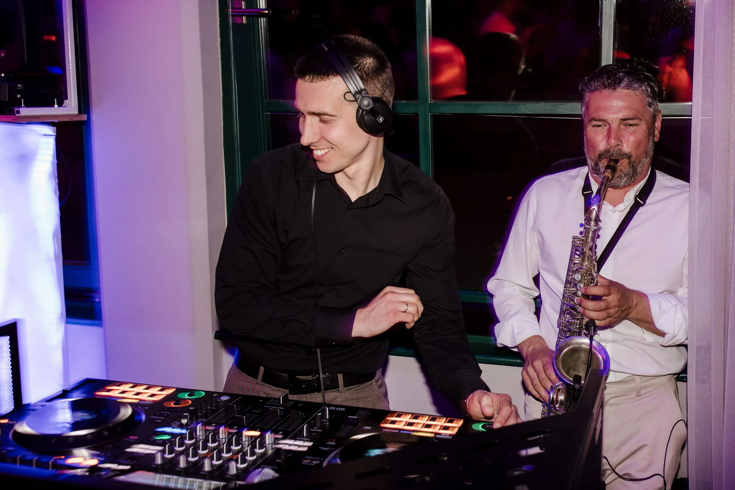 DJ Symart and a saxophonist performing together at Restoran Maksimir in Zagreb