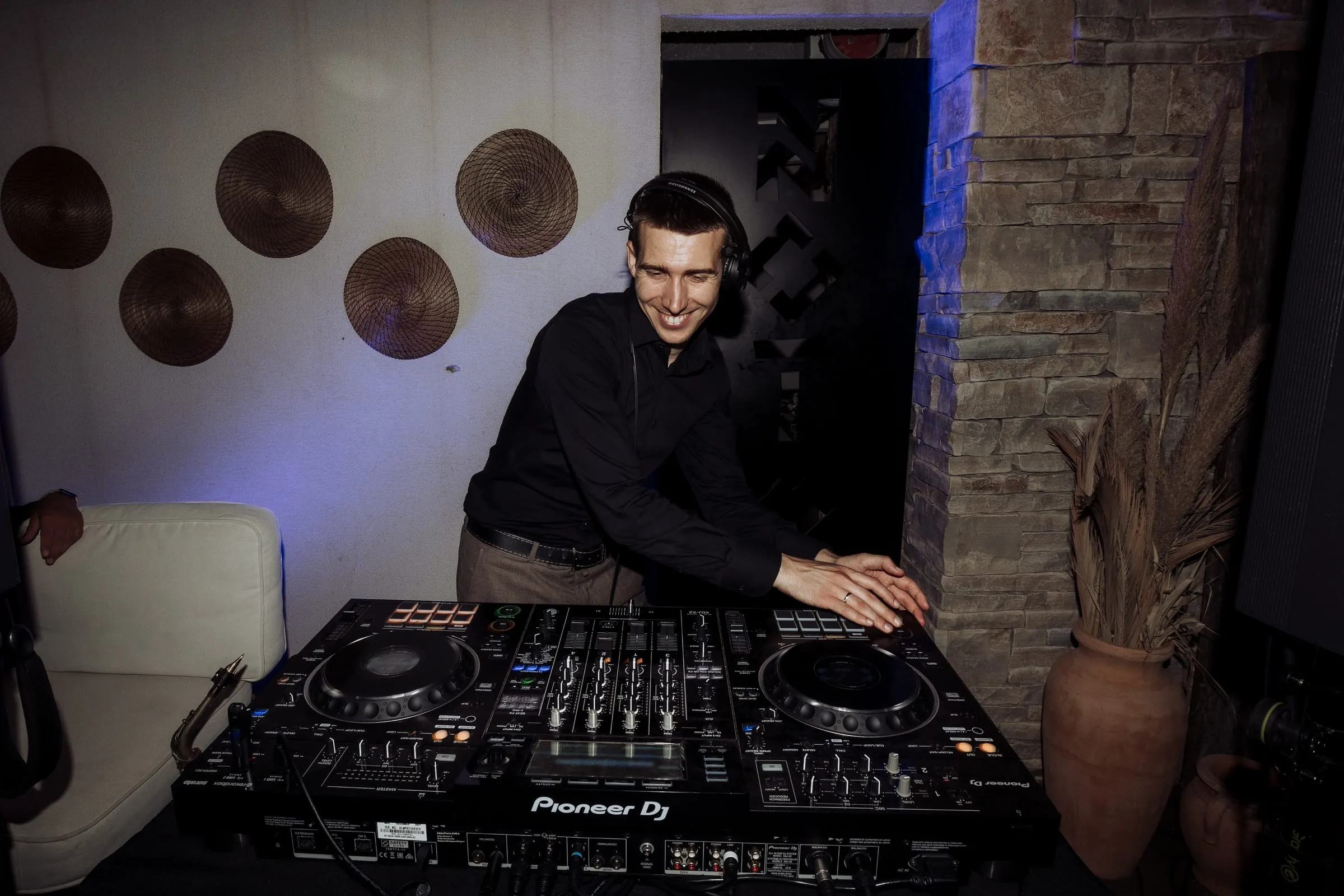 DJ Symart smiling at the decks at a wedding at Notos on Hvar