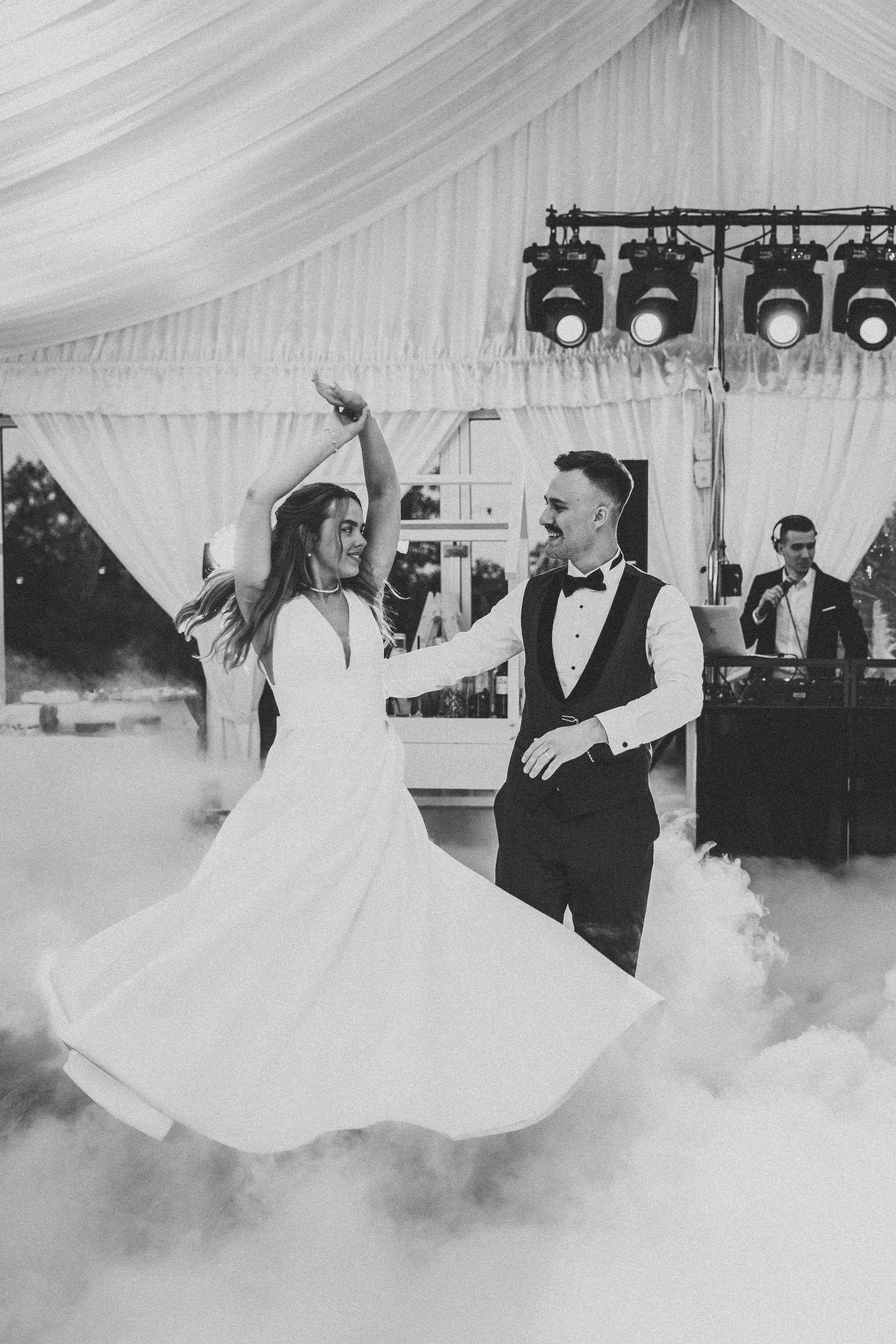 Black and white photo of a first dance in low fog under a marquee at Old Village