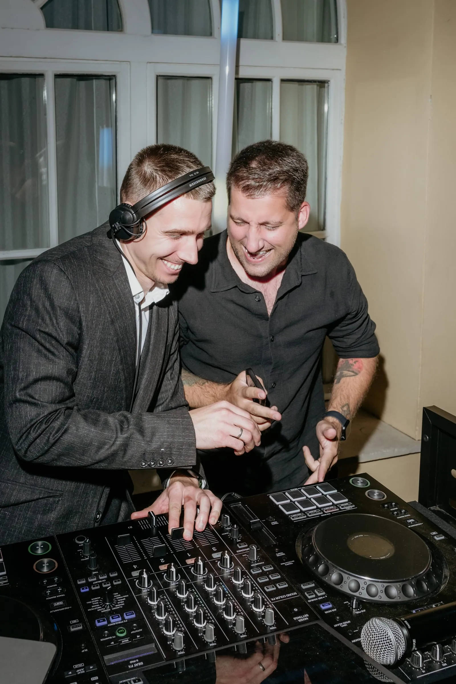 DJ Symart and a guest laughing together at the decks at Villa Dalmacija