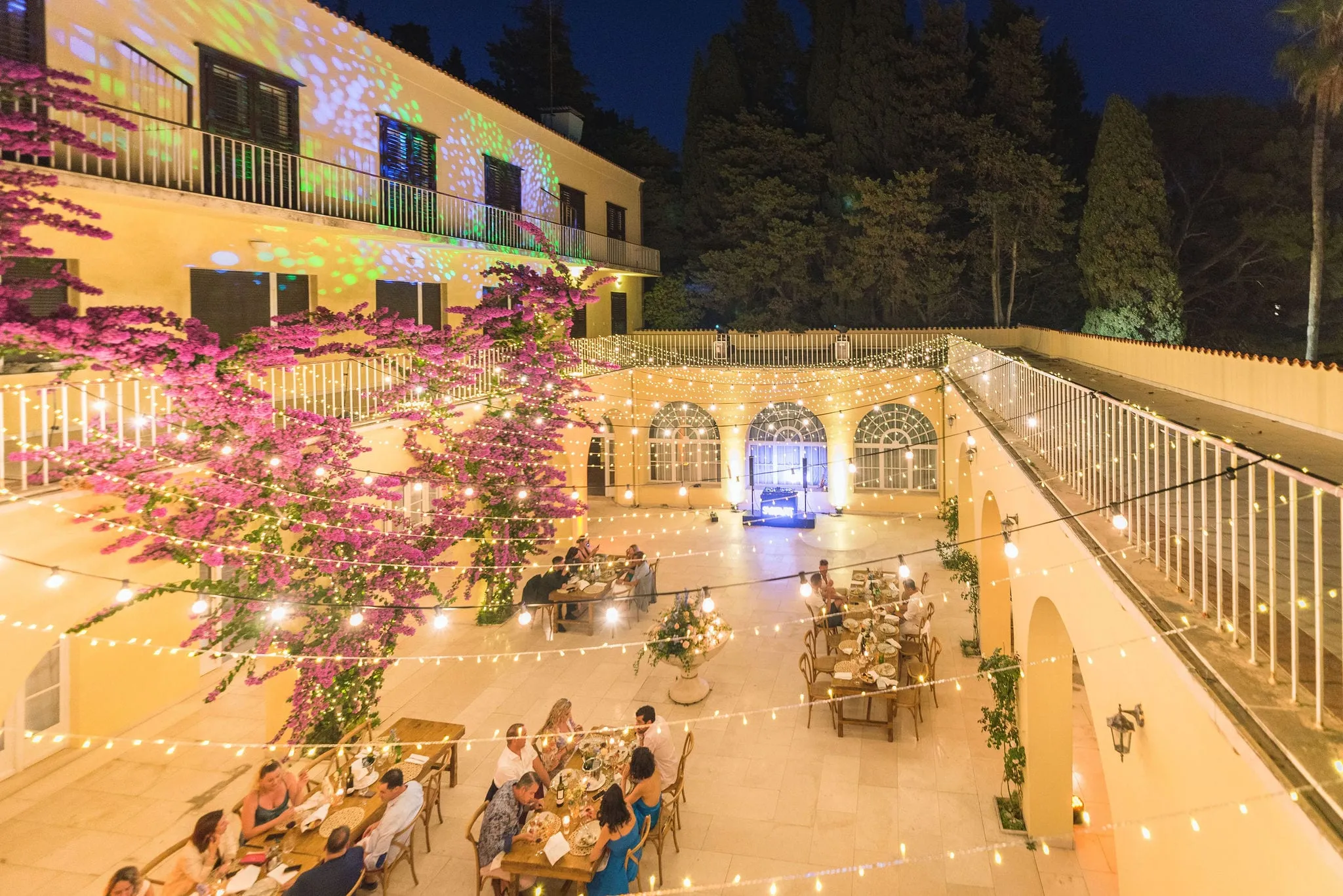The courtyard of Villa Dalmacija in Split lit up for a wedding dinner at night