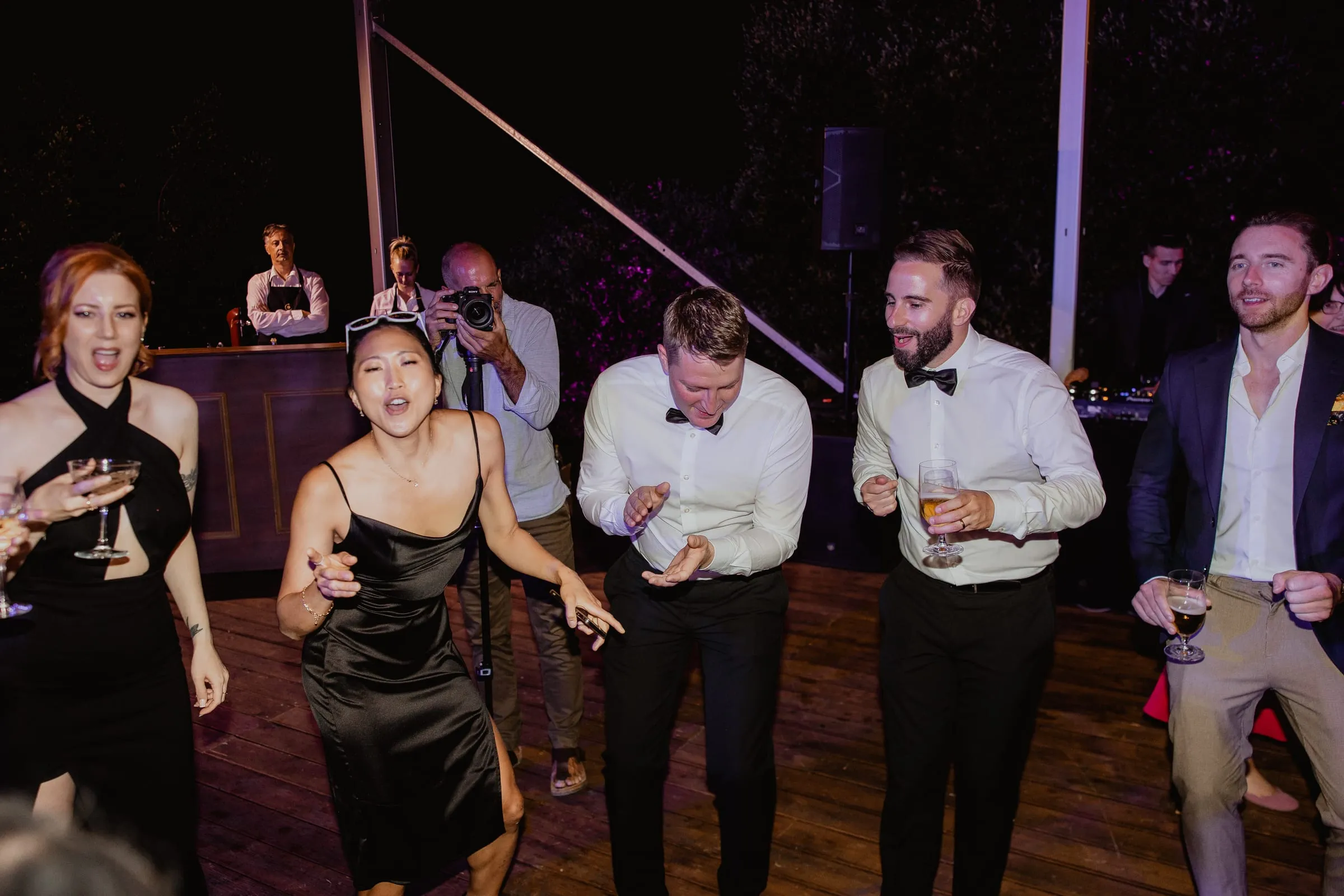 International wedding guests dancing at night at a wedding near Dubrovnik